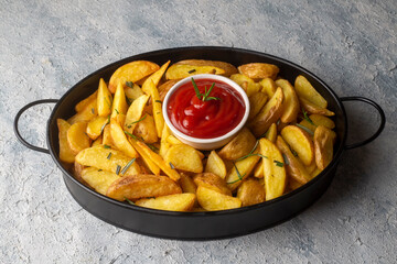 Roasted potato wedges with herbs and sea salt on plate, top view (Turkish name; elma dilim patates)