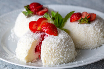 Delicious milk dessert; cup dessert with coconut and strawberry (Turkish name; fincan tatlisi