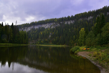 Autumn bad weather hides the Usvinskie Pillars stone in the Western Urals with a shroud of rain