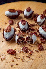 Fototapeta na wymiar dates covered with white chocolate and stuffed with pecan