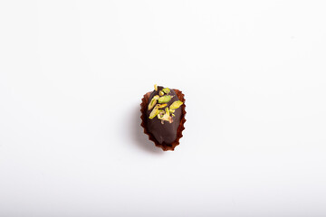 date dessert with Pistachio on top and dipped with chocolate
