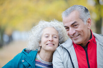 Senior couple smiling in autumn park