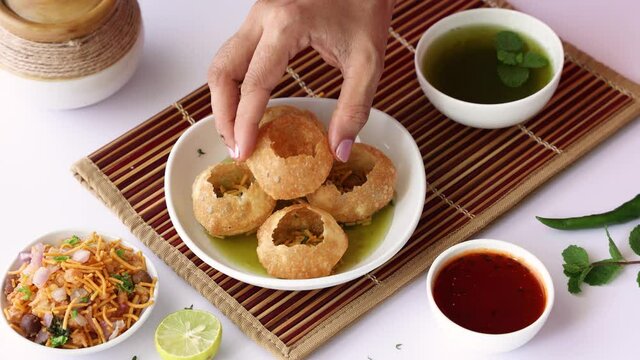 Girl women eating serving Pani puri golgappe with hand Chat item India. North Indian street food Indian panipuri snack 4K footage video tamarind water potato stuffing Delhi Mumbai Holi Diwali Dussehra