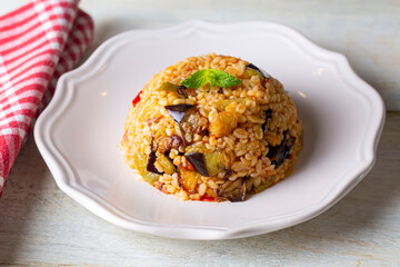 Traditional delicious Turkish food; Bulgur pilaf with eggplant and vegetables. (Turkish name; Patlicanli bulgur pilavi)