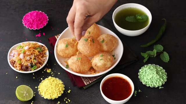 Girl women eating serving Pani puri golgappe with hand Chat item India. North Indian street food Indian panipuri snack 4K footage video tamarind water potato stuffing Delhi Mumbai Holi Diwali Dussehra