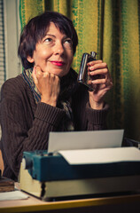 Vintage female writer reporter working behind his desk