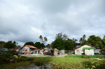 Fototapeta na wymiar THAILAND, BANGKOK: Scenic landscape view of isolated Thai island with palms and traditional houses 