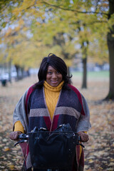 Fototapeta na wymiar Portrait smiling, confident senior woman bike riding in autumn park