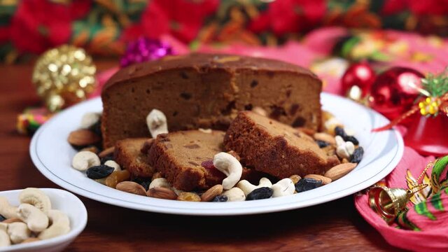 Homemade Christmas plum cake Indian Christmas celebration serving  India Kerala. 4K footage video Fruitcake made dried fruit, nuts, spices , rum for New Year party, Easter, Christmas Eve fruit cake 