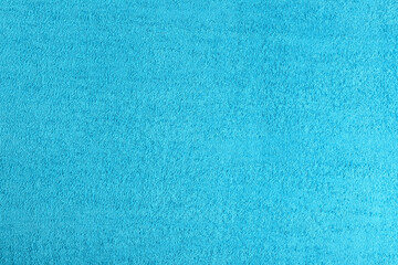 Clean light blue beach towel as background, closeup