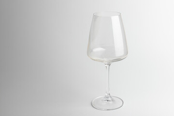 Empty transparent wine glass on the white background