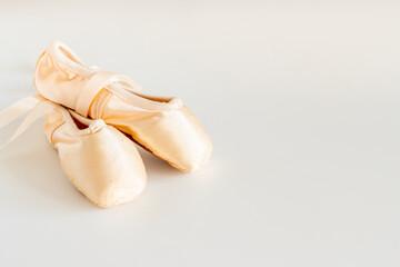 Pastel beige ballet pointe shoes or slippers with ribbon