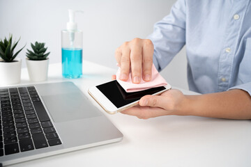 Germs elimination. Cleaning the smartphone screen with a fiber cloth