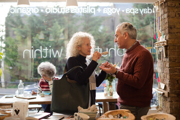 Senior couple talking and shopping at store