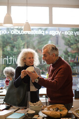 Senior couple talking and shopping at store
