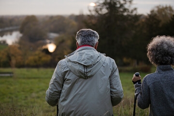 Affectionate senior couple with walking sticks