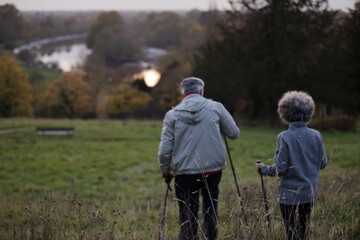 Affectionate senior couple with walking sticks