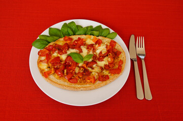 delicious large Italian bruschetta with juicy red tomatoes, mozzarella, garlic, olive oil and fresh basil leaves on a plate