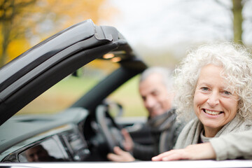 Smiling, affectionate senior couple in car