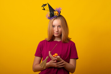 Happy young girl with pumpkin candy wearing Halloween costume.