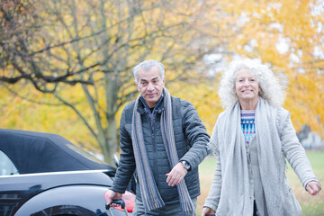 Obraz na płótnie Canvas Smiling, affectionate senior couple with suitcases