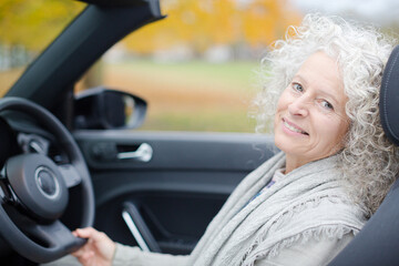 Portrait smiling, affectionate senior woman in car