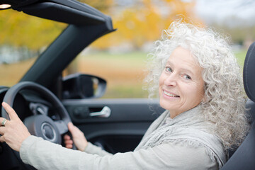 Portrait smiling, affectionate senior woman in car