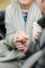 Fototapeta premium Affectionate senior couple holding hands in car