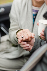 Affectionate senior couple holding hands in car