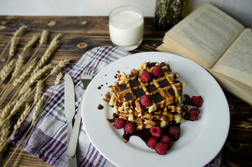 breakfast with Viennese waffles and milk. delicious breakfast with a book