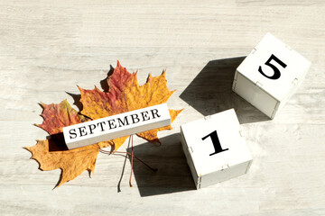 Calendar for September 15 : the name of the month of September in English, cubes with the number...