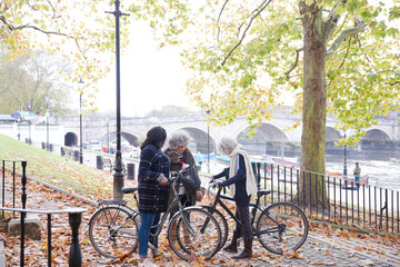 Obraz premium Portrait confident, smiling senior women bike riding in autumn park
