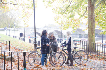 Obraz premium Portrait confident, smiling senior women bike riding in autumn park