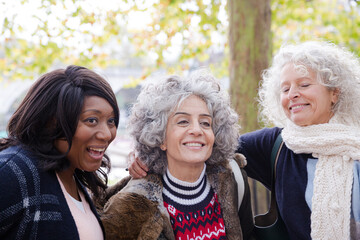 Fototapeta premium Portrait smiling, happy active senior women friends at autumn park