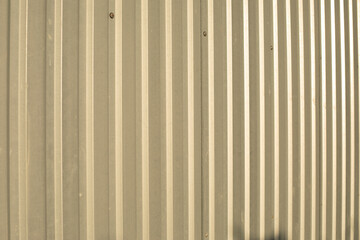 Fototapeta premium The texture of the metal fence. Stainless steel in sunlight.