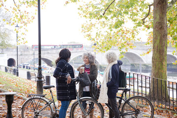 Obraz premium Portrait confident, smiling senior women bike riding in autumn park