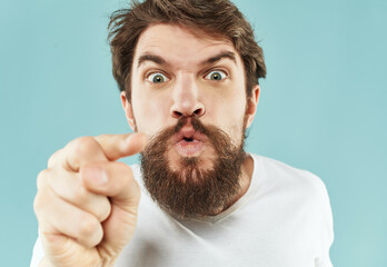 Obraz premium Man in a white t-shirt expressive look discontent close-up