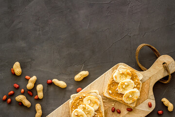 Breakfast with peanut butter sandwiches on white bread, top view