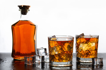 Golden whiskey in glass with ice cubes