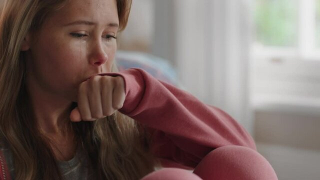 sad teenage girl crying at home feeling alone depressed teen thinking of emotional break up sitting in bedroom