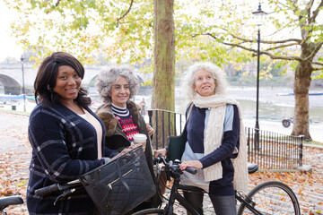 Fototapeta na wymiar Portrait confident, smiling senior women bike riding in autumn park