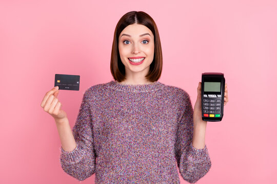 Photo of cheerful lady presenting debit card terminal reader wear knitted pullover isolated pink color background