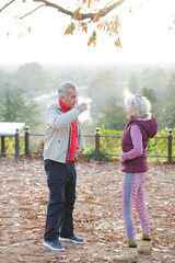 Fototapeta premium Affectionate active senior couple at autumn park
