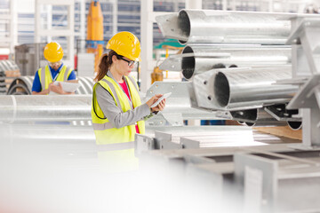 Workers with digital tablet working in factory