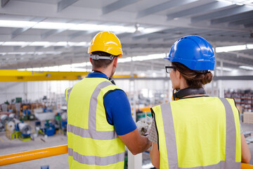 Supervisor and worker talking in steel factory