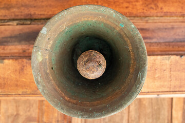 Old bell corroded by rust with the predominant brown color
