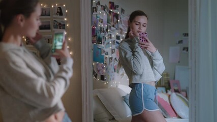 beautiful teenage girl taking selfie photo using smartphone posing in mirror sharing stylish fashion on social media enjoying weekend at home teen self image