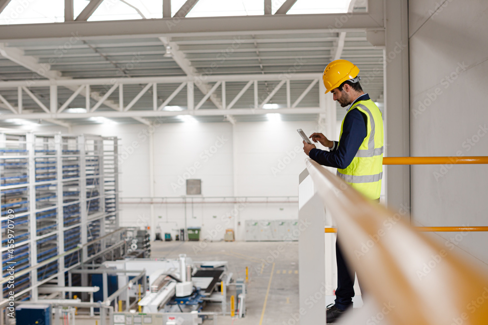 Wall mural portrait confident supervisor with digital tablet on platform in factory