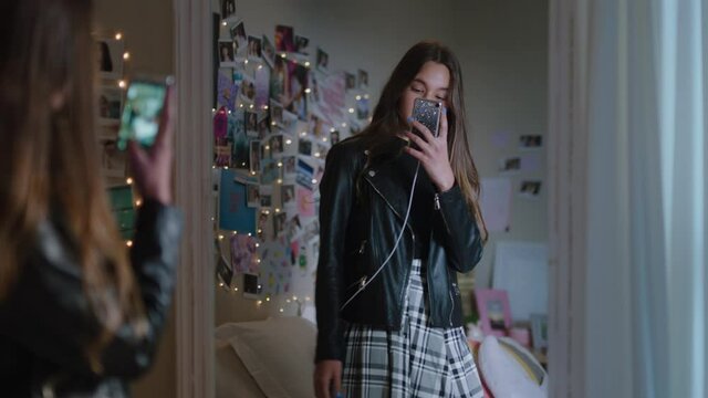 beautiful teenage girl taking selfie photo using smartphone posing in mirror sharing stylish fashion on social media enjoying weekend at home teen self image