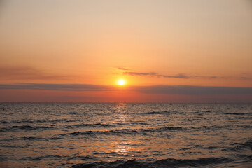 Fototapeta na wymiar Beautiful sky with sun over sea during sunset